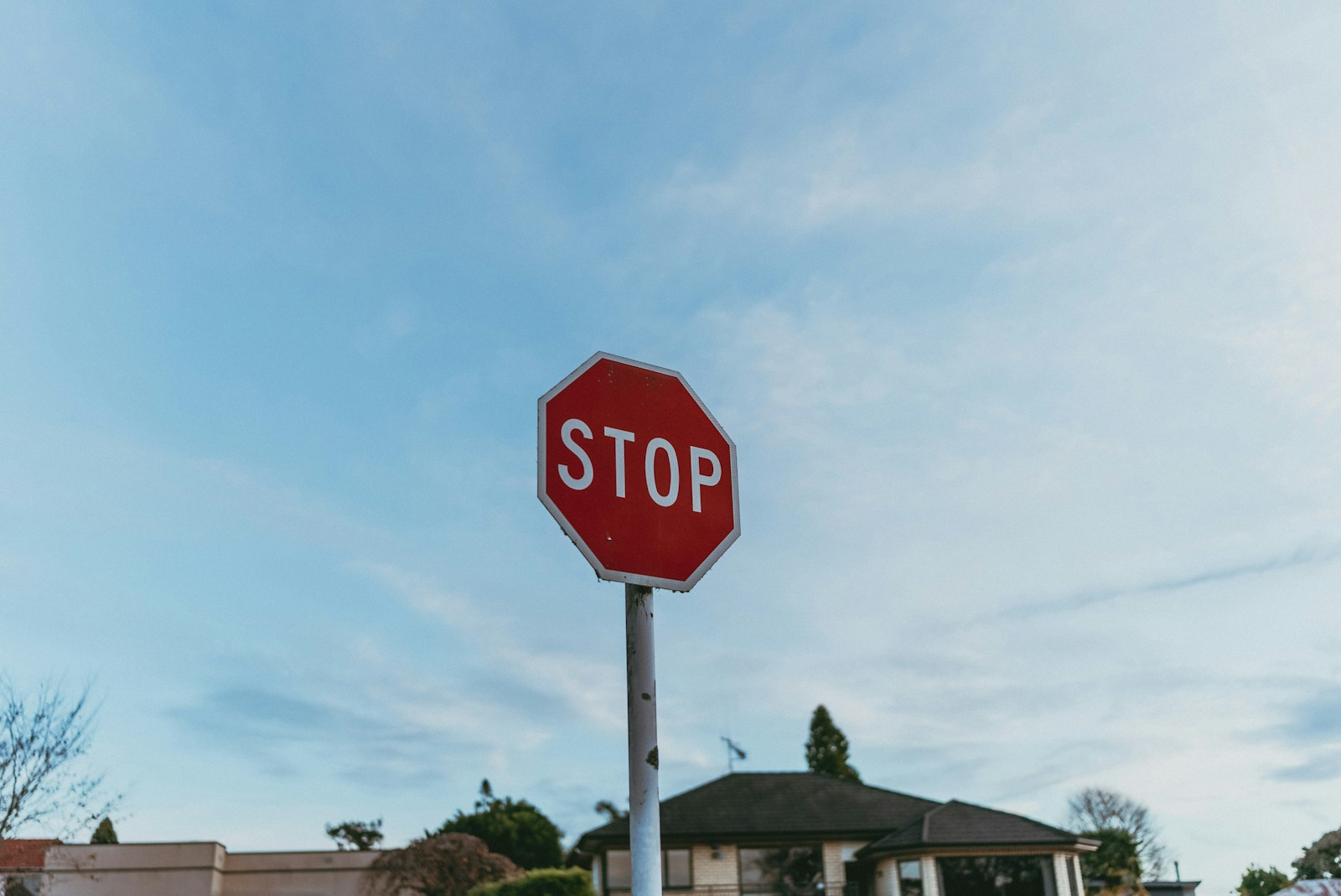 A red stop sign sitting on the side of a road
