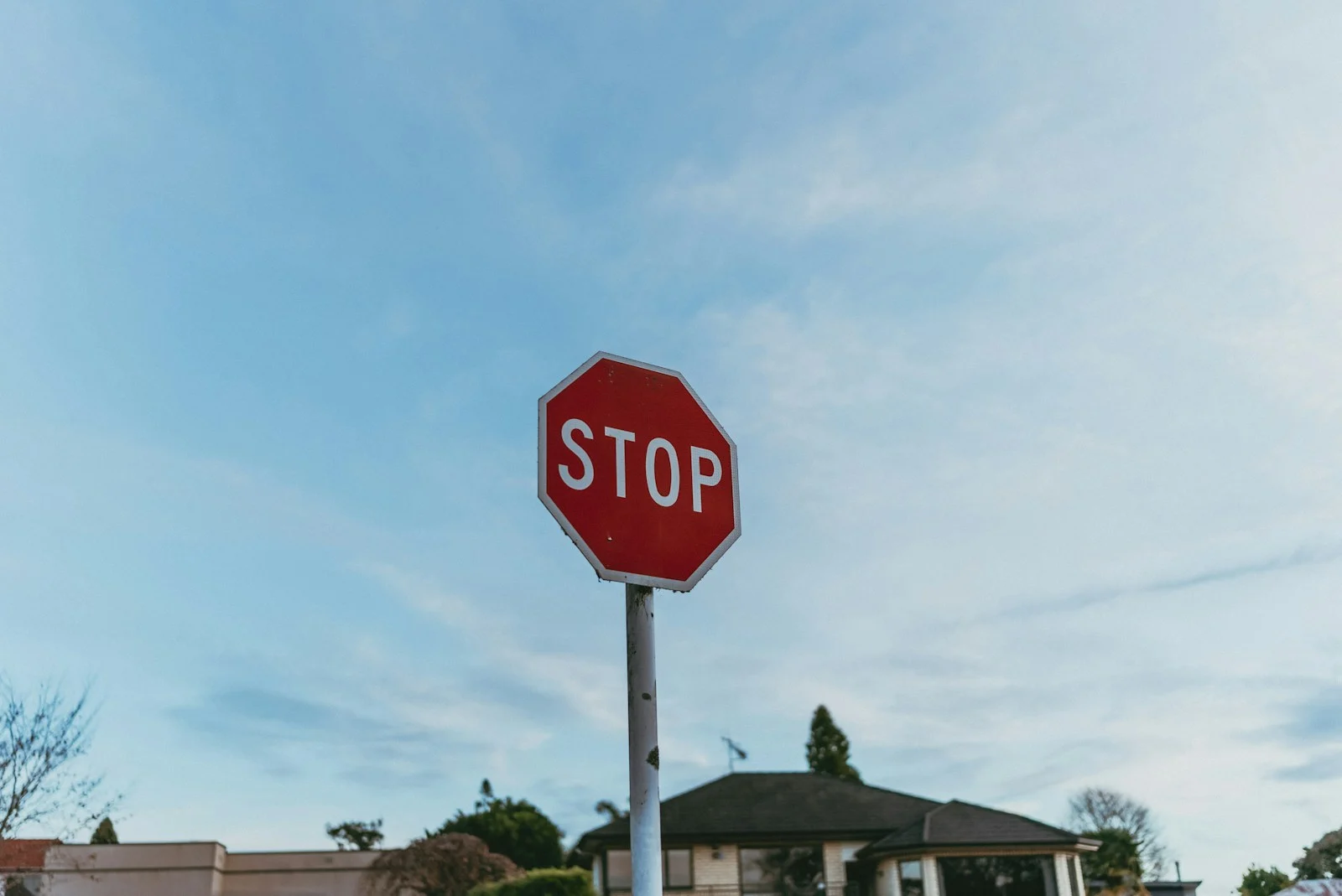 A red stop sign sitting on the side of a road