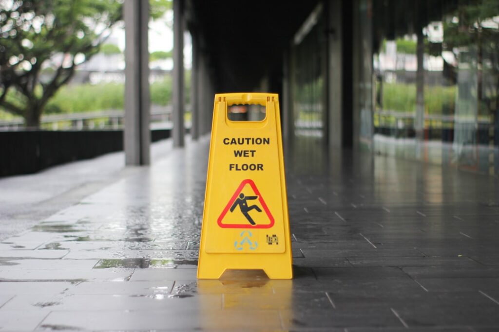 Yellow caution wet floor signage — slip and fall liability