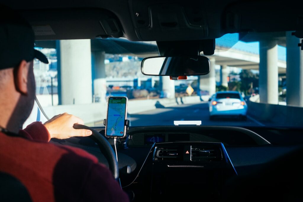 person holding iphone 6 inside car — Photo by Paul Hanaoka on Unsplash