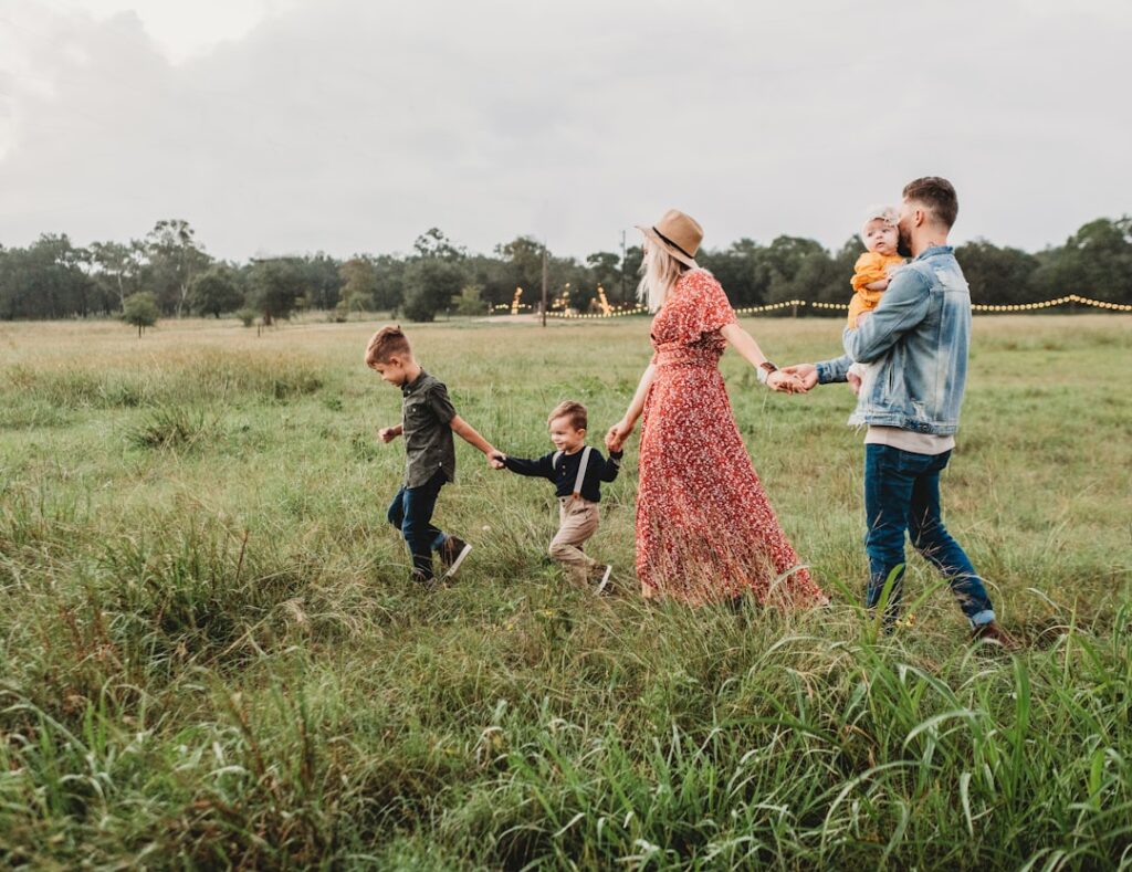 woman holding man and toddler hands during daytime — Photo by Jessica Rockowitz on Unsplash