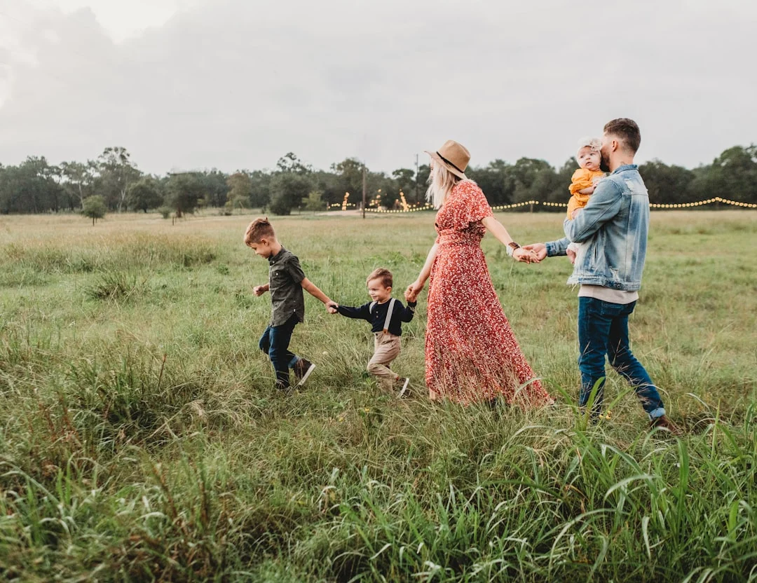 woman holding man and toddler hands during daytime — Photo by Jessica Rockowitz on Unsplash