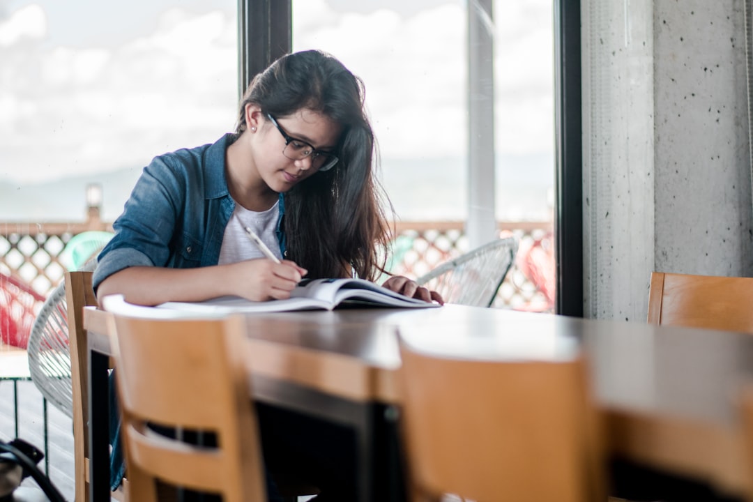 Person writing in book — NJ LLC operating agreement