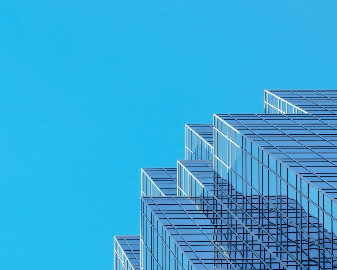 Modern glass skyscraper corporate office building - EB-1C multinational manager