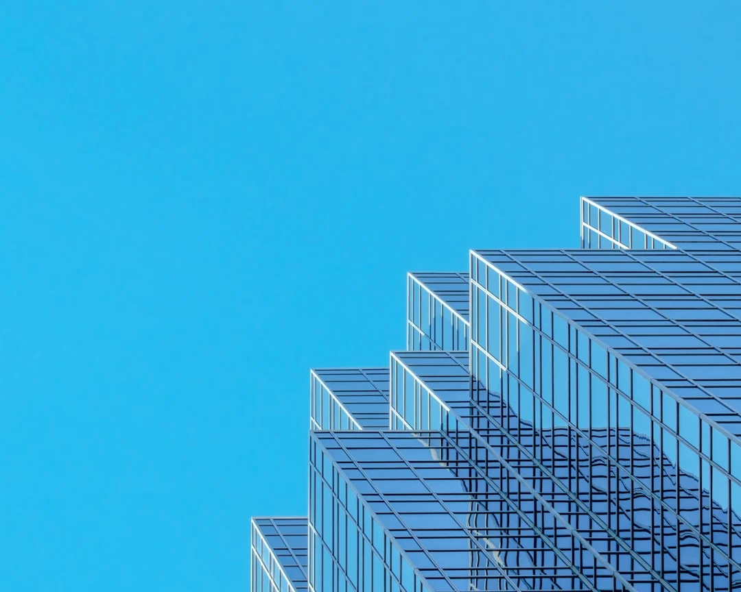 Modern glass skyscraper corporate office building - EB-1C multinational manager