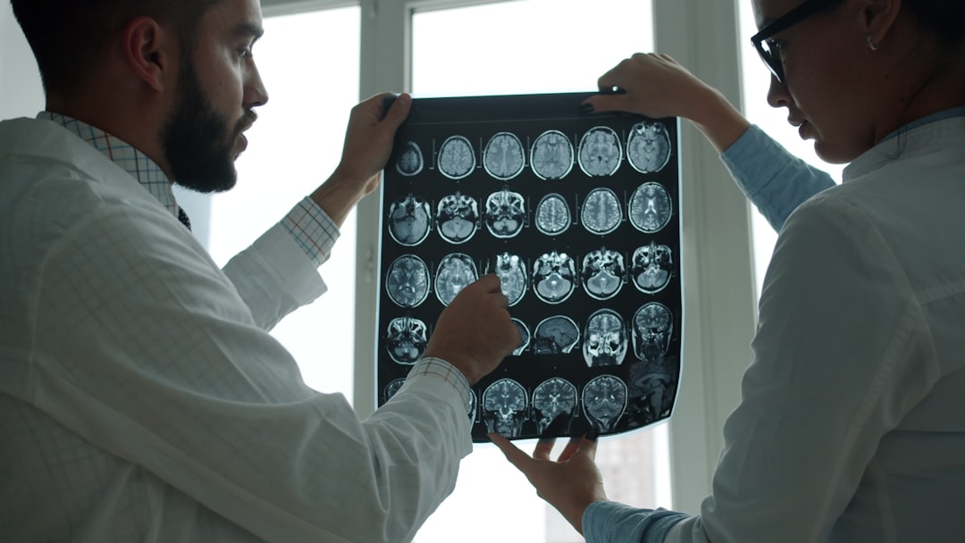 Doctors examining MRI scans representing the medical evidence required to meet NJ Verbal Threshold in personal injury lawsuits