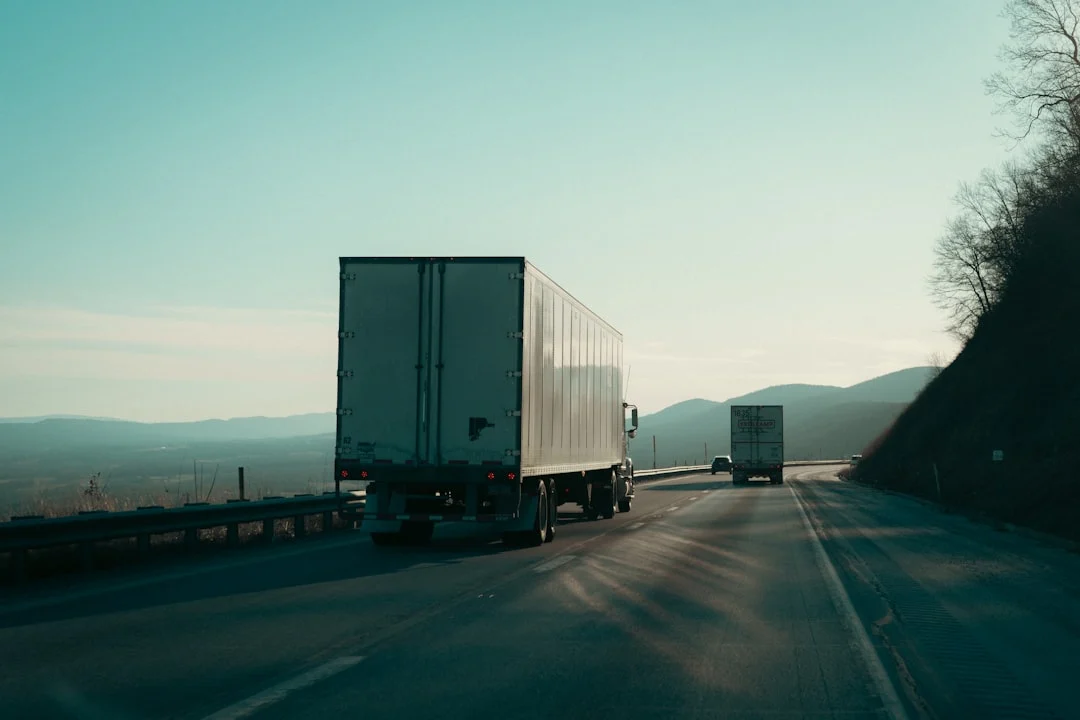 Semi trucks on highway representing NJ trucking accident cases involving FMCSA and CDL commercial insurance