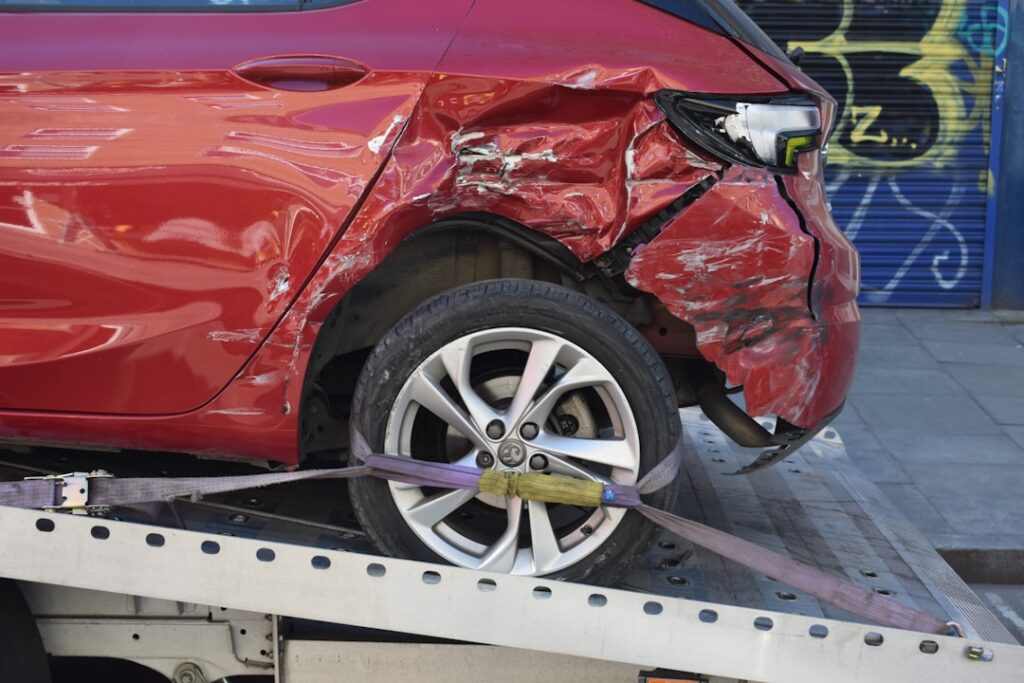 Damaged car being towed representing an uninsured motorist claim after a NJ auto accident