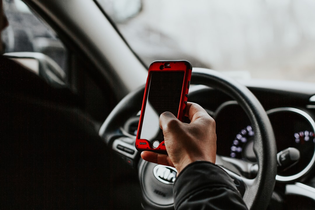 Smartphone at steering wheel - distracted driving hand-held device