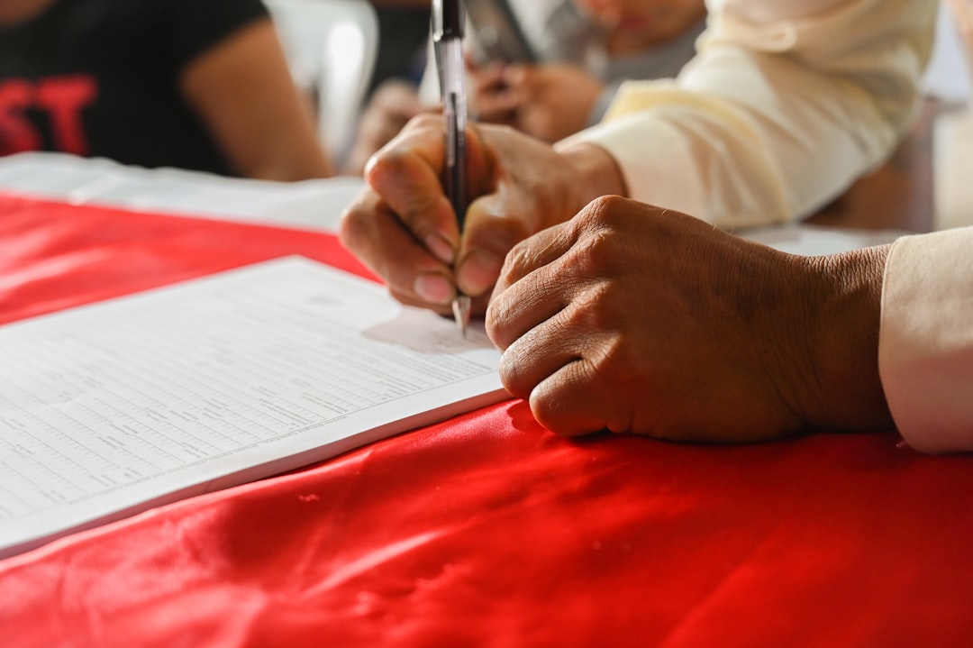 Person signing legal contract document representing NJ prenuptial agreement enforcement