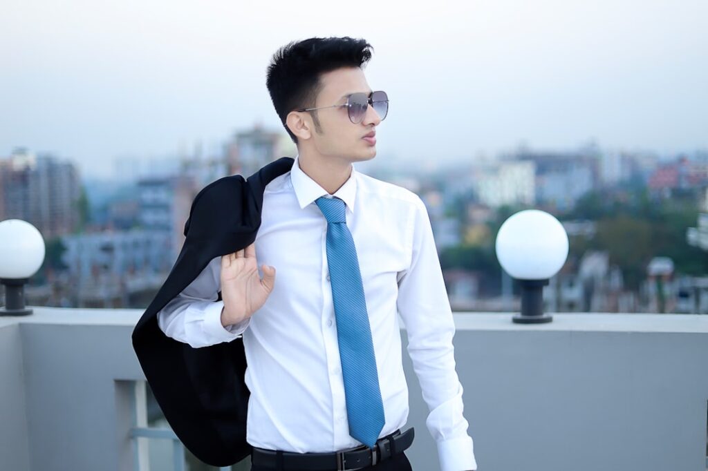a man in a suit and tie standing on a roof