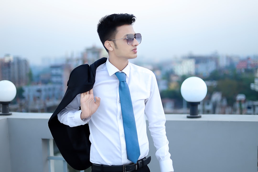 a man in a suit and tie standing on a roof