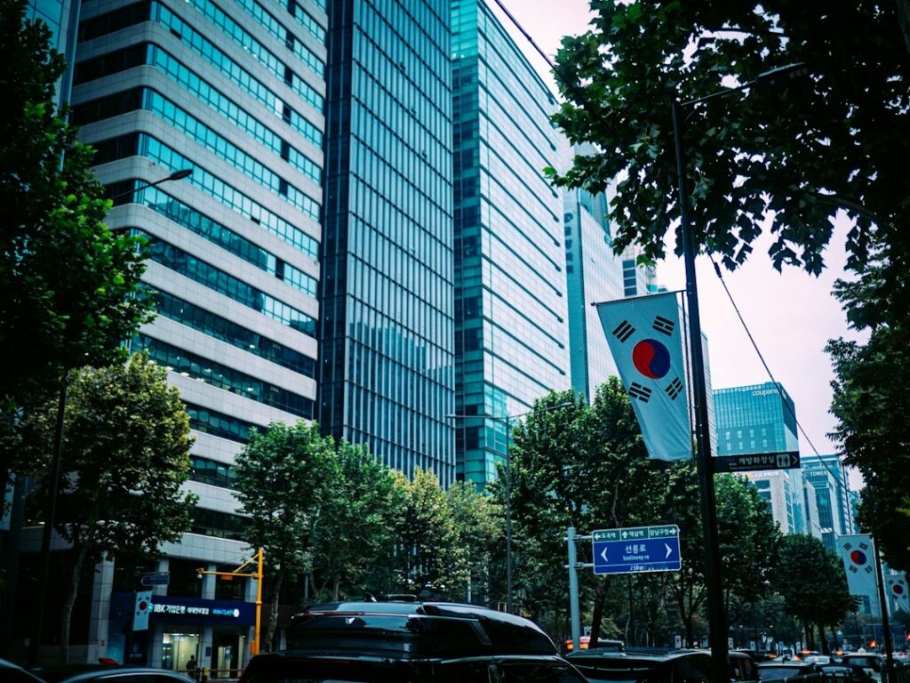 Modern skyscrapers with trees and korean flag