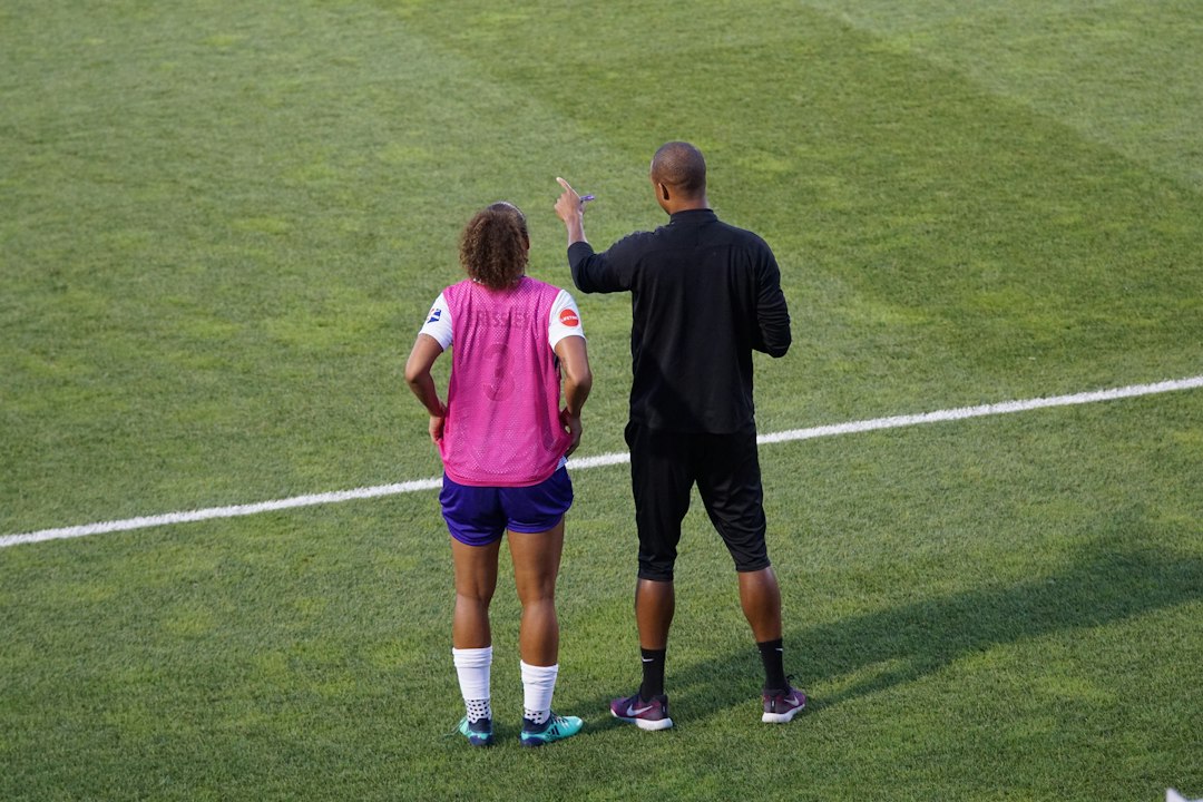man and woman standing on field
