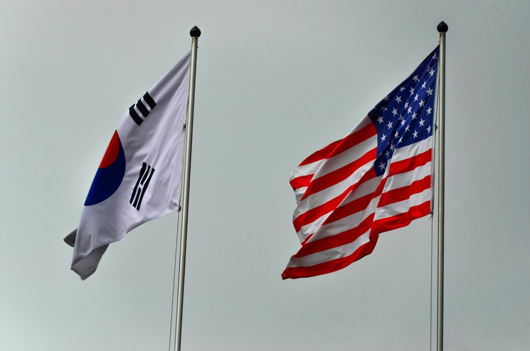 South korean and american flags flying