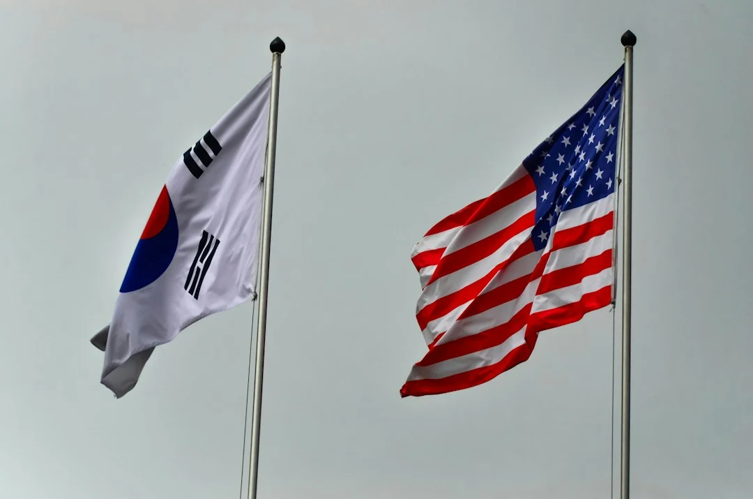 South korean and american flags flying