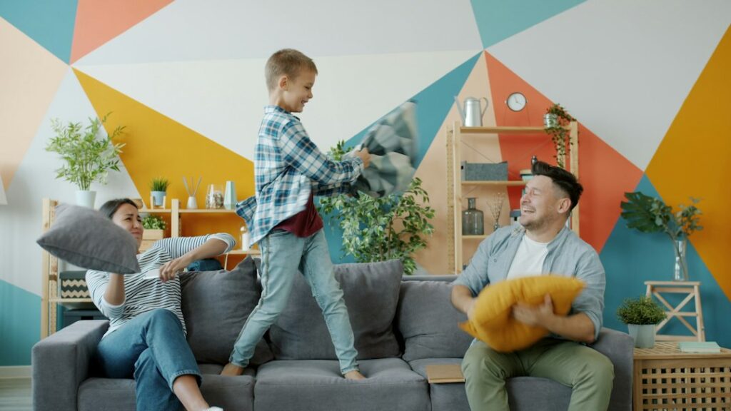 Family having a pillow fight on the couch