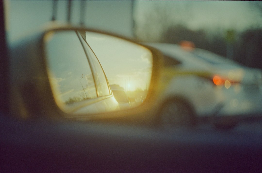 Sunset reflected in a car's side mirror